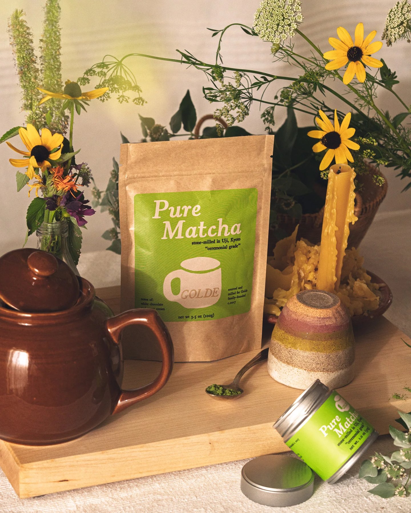 Golde Pure Matcha pouch with teapot flowers and open tin on tray.