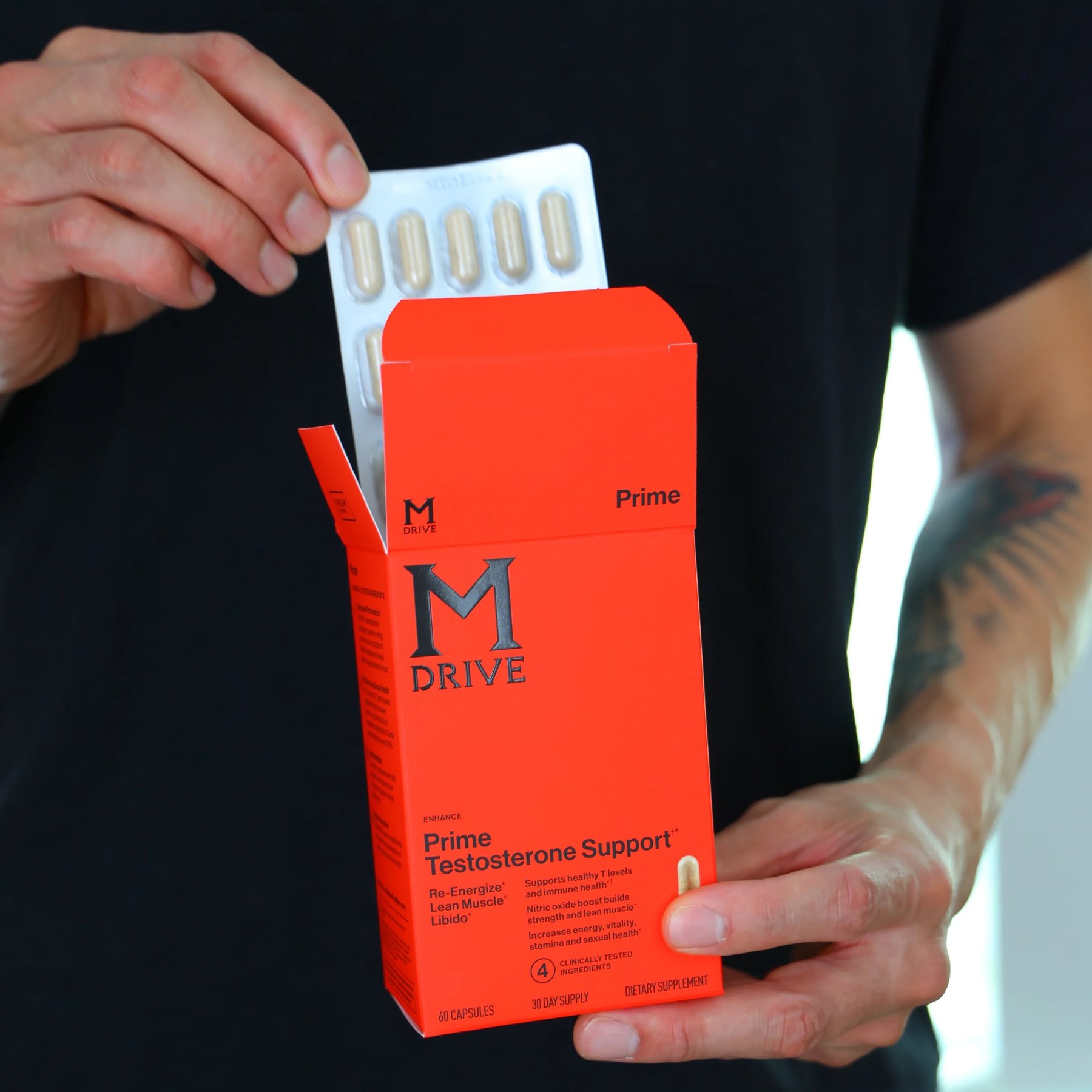 Hands removing capsules from an M Drive Prime box.