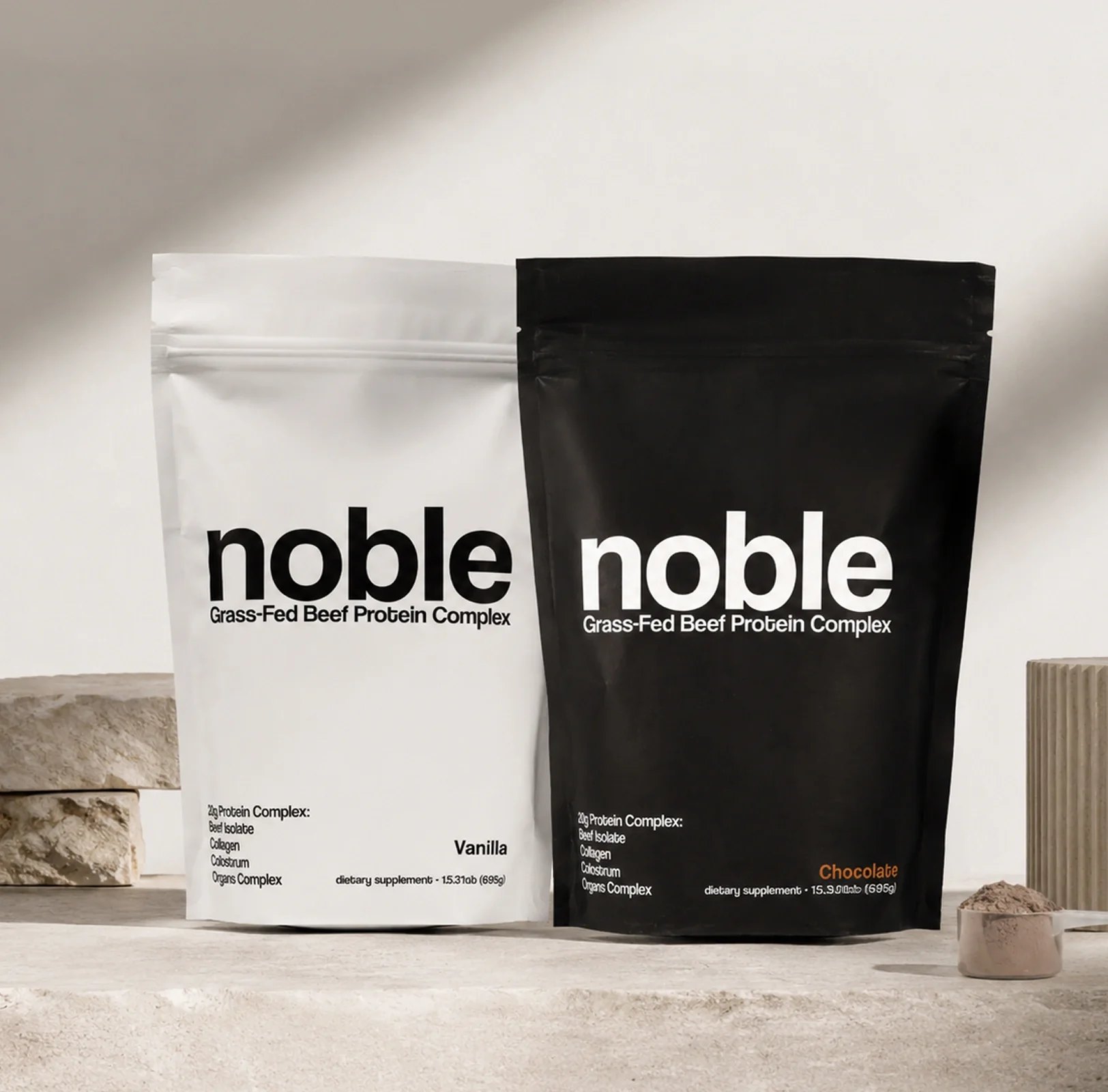 White vanilla and black chocolate Noble protein pouches together.