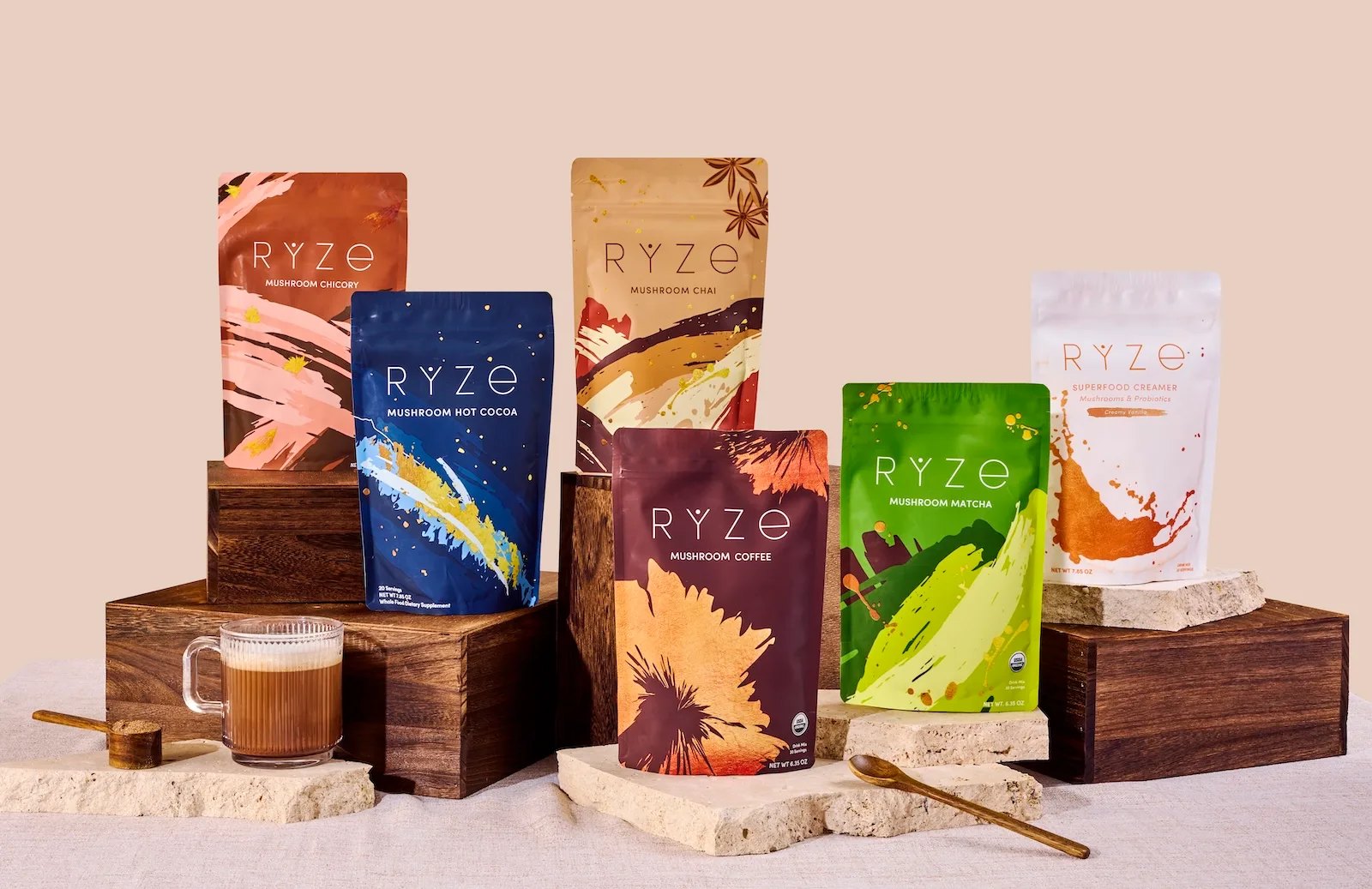 Assorted RYZE product pouches displayed with a mug of coffee.